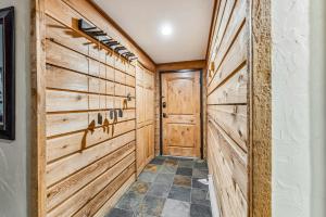 a hallway with wooden walls and a door at Rocky Mountain Mama in Breckenridge