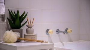 a bathroom with a bath tub and a mortar and pestle at Jervis Joy in Callala Beach +23 photos