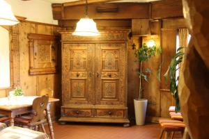 an old wooden door in a room with a table at Hotel Heimgartl in Innsbruck