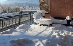 two chairs covered in snow next to a building at Hotel Heimgartl in Innsbruck