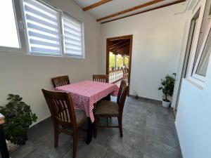 a dining room with a table and chairs at 9 mezeta in Pirot