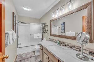 a bathroom with a sink and a toilet and a mirror at Tahoe Retreat with Scenic Views and Spacious Deck in Tahoe Vista +19 photos