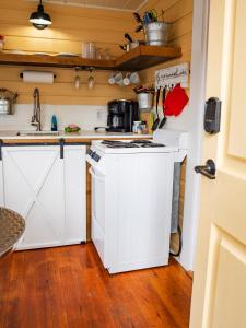 a kitchen with a white stove and a sink at Cottage 11 - 1 Bed / 1 Bath w/ Private Courtyard in Wolfeboro