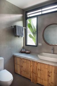 a bathroom with a sink and a mirror at Bungalow Khao Lak in Khao Lak +16 photos