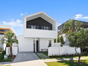 a white house with a black roof at Cylinders Coastal Deluxe in Kingscliff