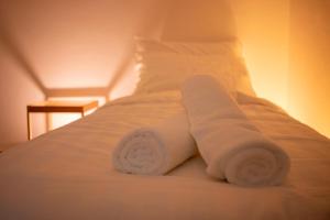 a couple of towels are stacked on a bed at MARI Suites in Malacca +27 photos