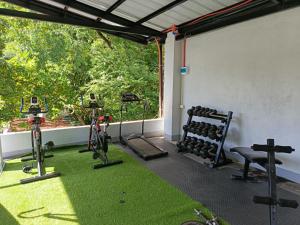 a gym with bikes and weights in a room at Harbour Bliss Hotel in Coron