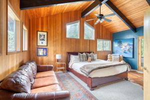 a bedroom with a bed and a leather couch at The Lodge at Highland Farms in Brightwood
