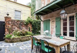 a wooden table and chairs on a patio at Chic Cottage near the Lower French Quarter in New Orleans