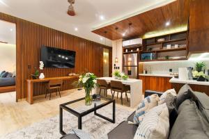 a living room with a couch and a dining room at Stunning 2BR with Plunge Pool - Rooftop Sea Views in Playa del Carmen