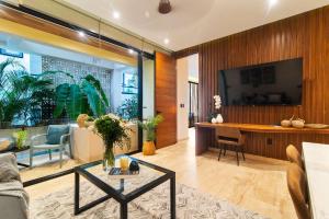 a living room with a glass table in a room at Stunning 2BR with Plunge Pool - Rooftop Sea Views in Playa del Carmen