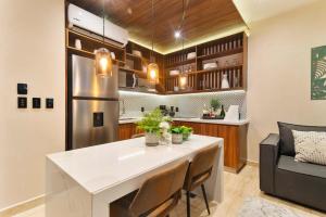 a kitchen with a large white island in a room at Stunning 2BR with Plunge Pool - Rooftop Sea Views in Playa del Carmen