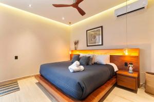 a bedroom with a bed with a teddy bear on it at Stunning 2BR with Plunge Pool - Rooftop Sea Views in Playa del Carmen