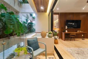 a lobby with a chair and a desk with a television at Stunning 2BR with Plunge Pool - Rooftop Sea Views in Playa del Carmen