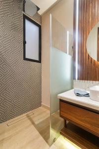 a bathroom with a sink and a mirror at Stunning 2BR with Plunge Pool - Rooftop Sea Views in Playa del Carmen