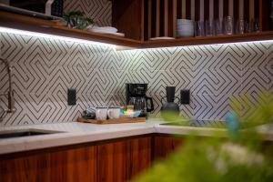 a kitchen with a counter top with a sink and a counter top at Stunning 2BR with Plunge Pool - Rooftop Sea Views in Playa del Carmen