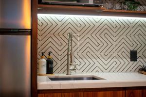 a kitchen sink with a stainless steel faucet at Stunning 2BR with Plunge Pool - Rooftop Sea Views in Playa del Carmen