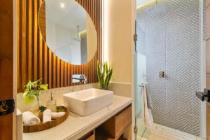 a bathroom with a sink and a mirror at Stunning 2BR with Plunge Pool - Rooftop Sea Views in Playa del Carmen
