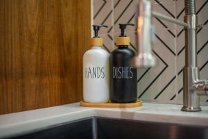 two bottles sitting on a counter next to a sink at Stunning 2BR with Plunge Pool - Rooftop Sea Views in Playa del Carmen