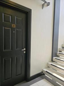 a black door with a sign that reads exit at First Pacific Inn Davao in Davao City +10 photos