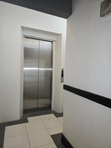 a elevator with a metal door in a building at First Pacific Inn Davao in Davao City
