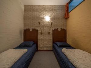 a room with two beds in a brick wall at Luxe Glamping Getaway in Bruinisse +32 photos
