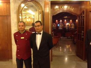 two men standing next to each other in a restaurant at El Hana International in Tunis