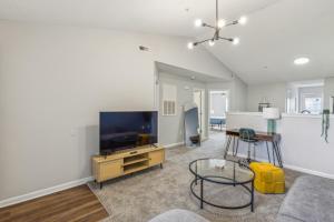 a living room with a flat screen tv and a couch at Cb 3508-301 Fayetteville Oasis I Modern, Comfy in Fort Bragg