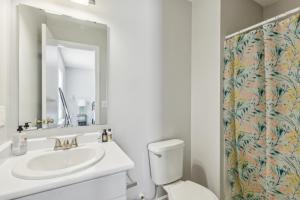 a bathroom with a sink and a toilet and a mirror at Cb 3508-301 Fayetteville Oasis I Modern, Comfy in Fort Bragg +19 photos