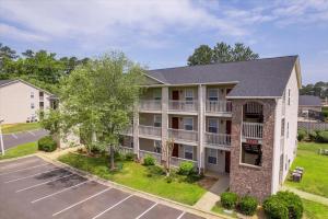 an apartment building with a parking lot at Cb 3508-301 Fayetteville Oasis I Modern, Comfy in Fort Bragg