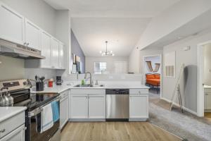 a kitchen with white cabinets and a sink at Cb 3508-301 Fayetteville Oasis I Modern, Comfy in Fort Bragg