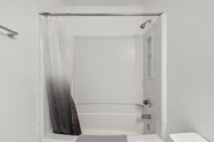 a white bathroom with a shower and a sink at Northcliffe 104 I Fully Furnished 1 Bedroom 1bth in Winston-Salem