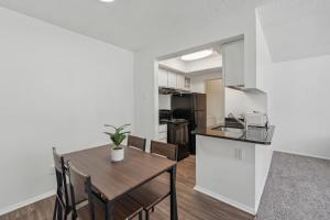 a kitchen and dining room with a table and chairs at Northcliffe 104 I Fully Furnished 1 Bedroom 1bth in Winston-Salem +7 photos