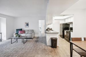 a white living room with a couch and a table at Northcliffe 1107 I Fully Furnished 2 Bedroom 2bth in Winston-Salem