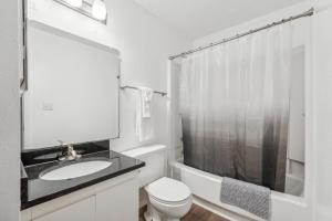 a white bathroom with a sink and a toilet at Northcliffe 1107 I Fully Furnished 2 Bedroom 2bth in Winston-Salem