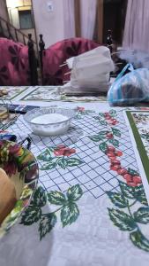 a table with a white table cloth with flowers on it at Listo para habitar in La Paz