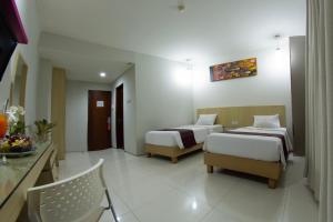 Voodi või voodid majutusasutuse Lombok Plaza Hotel and Convention toas