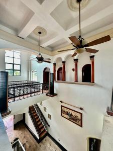 a staircase in a building with a ceiling fan at Gracey Dive Resort and Restaurant in Dauin
