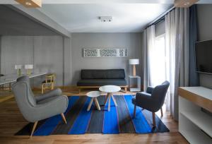 a living room with a couch and a table and chairs at Hotel Arenales in Buenos Aires