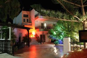 a house with a christmas tree in front of it at Prasonisi Club in Kattavía