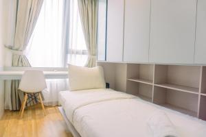 a small bedroom with a bed and a window at Luxury Studio at Daan Mogot City Apartment By Travelio in Jakarta +14 photos