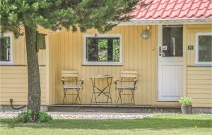 two chairs and a table in front of a house at Three-Bedroom Holiday Home In Oksbol in Oksbøl
