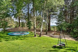 a backyard with a trampoline in the grass at Beautiful Newly Built House In Lovely Surroundings in Ebeltoft