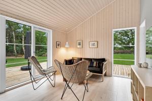 a living room with chairs and a couch at Beautiful Newly Built House In Lovely Surroundings in Ebeltoft