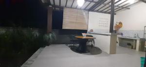 a patio with a table and a counter in a building at The Carik Homestay in Tabanan