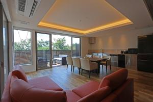 a living room with a couch and a table at Wellリゾート富士 in Gotemba +54 photos
