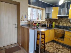 a kitchen with a counter with two glasses of wine at Тихий уголок in Aktau +11 photos