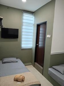 Ein Bett oder Betten in einem Zimmer der Unterkunft Hotel Seri Intan Tampin