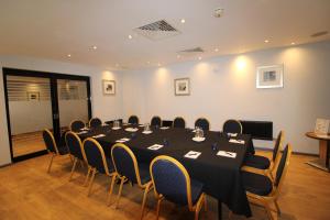 a conference room with a long table and chairs at The Stuart Hotel, Derby City Centre, Sure Collection by Best Western in Derby
