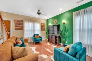 a living room with blue couches and a television at Cozy 2B Townhouse - Hot Tub in Concord